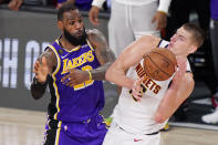 Los Angeles Lakers' LeBron James (23) and Denver Nuggets' Nikola Jokic (15) battle for the ball during the second half of an NBA conference final playoff basketball game Saturday, Sept. 26, 2020, in Lake Buena Vista, Fla. The Lakers won 117-107 to win the series 4-1. (AP Photo/Mark J. Terrill)