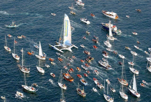 A flotilla of boats accompanies Ellen MacArthur as she returns to the UK