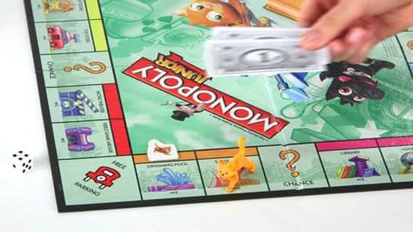 A Monopoly board with a number of pieces on it