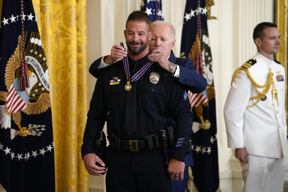 CORRECTS FROM LITTLETOWN TO LITTLETON - President Joe Biden presents the Medal of Valor, the nation's highest honor for bravery by a public safety officer, to Cpl. Jeffrey Farmer, of the Littleton, Colo., Police Dept., during an event in the East Room of the White House, Wednesday, May 17, 2023, in Washington. (AP Photo/Evan Vucci)