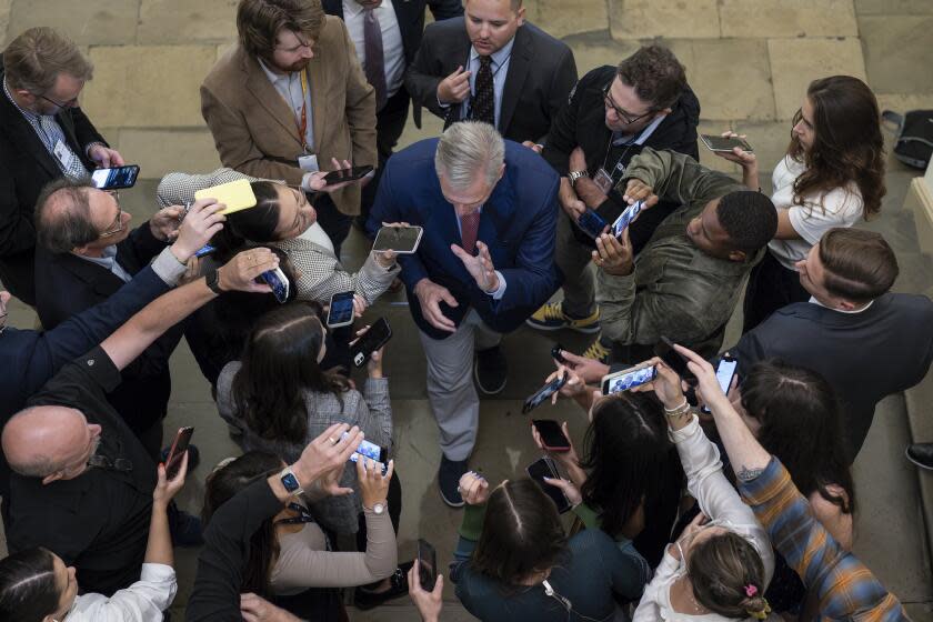 Speaker of the House Kevin McCarthy, R-Calif., is surrounded by reporters looking for updates on plans to fund the government and avert a shutdown, at the Capitol in Washington, Friday, Sept. 22, 2023. (AP Photo/J. Scott Applewhite)