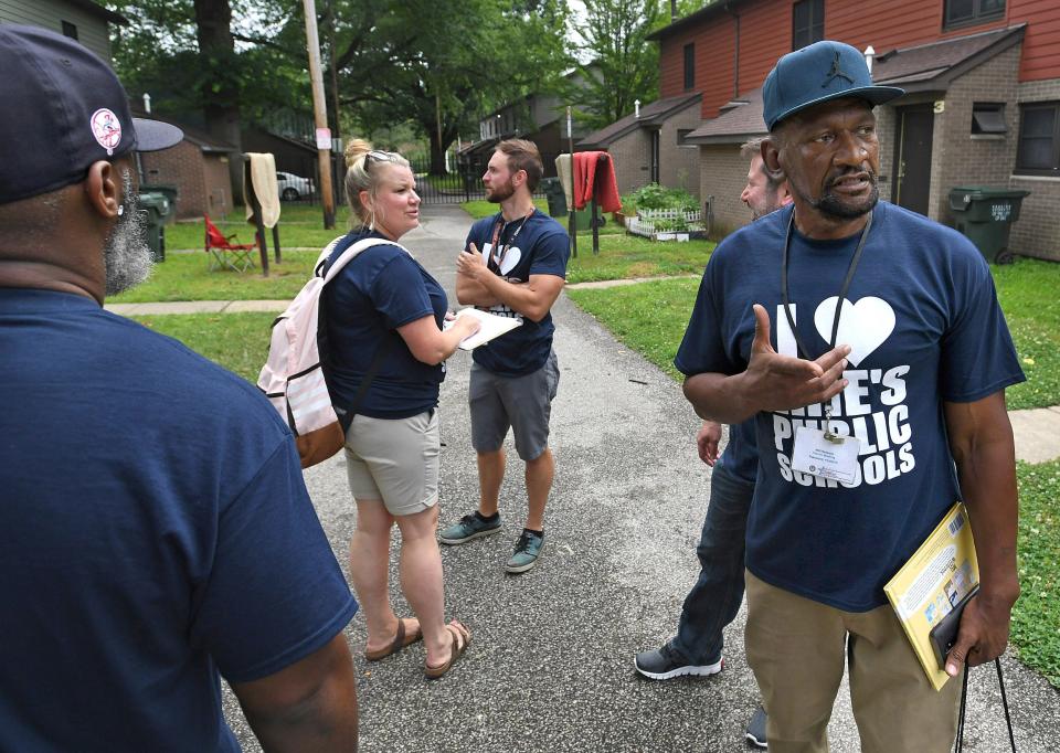 Daryl Craig, far right, is part of an Erie School District door-to-door team back on July 11, 2019.