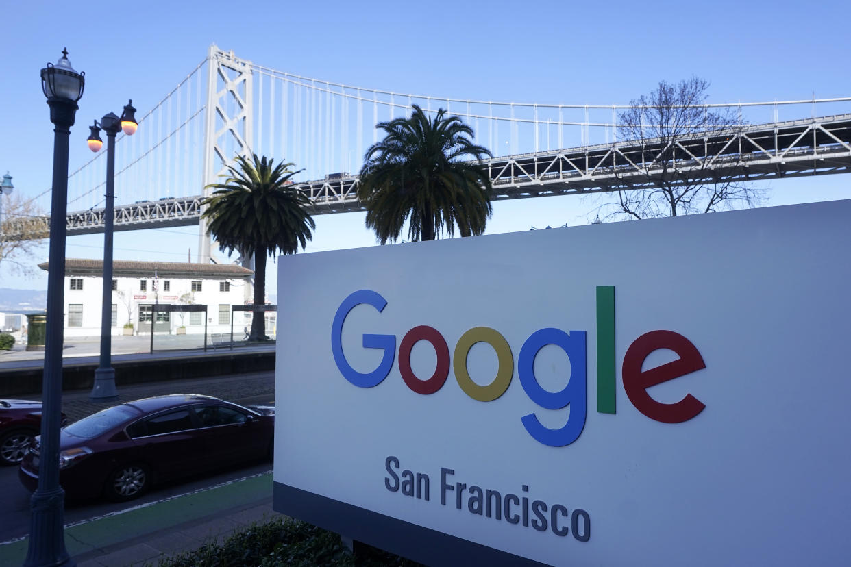 FILE - The San Francisco-Oakland Bay Bridge is seen behind a Google sign at the company's office in San Francisco on April 12, 2023. Google lost an antitrust lawsuit over barriers to its Android app store, as a federal court jury has decided that the company's payments system was anticompetitive and damaged smartphone consumers and software developers. (AP Photo/Jeff Chiu, File)