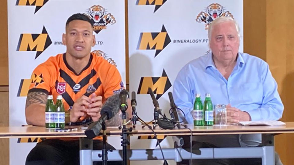 Clive Palmer (pictured right) sits next Israel Folau (pictured left) in a media conference for the Southport Tigers.