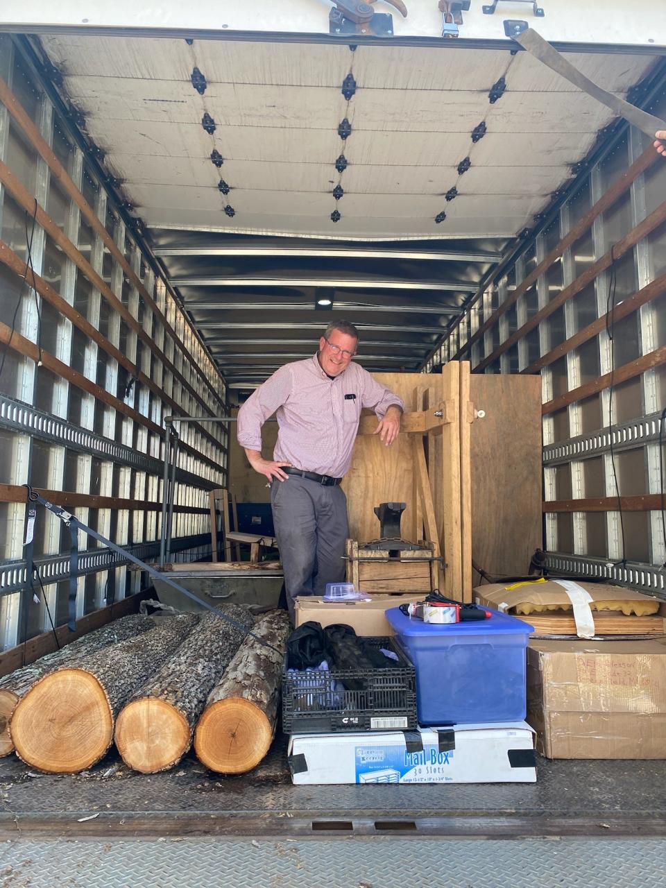 Missouri State University Dean of Libraries Thomas Peters poses for a photo with white oak logs in the back of a U-Haul on Missouri State's campus. Peters transported four six-foot white oak logs from Springfield to Washington D.C. for the annual Smithsonian Folklife Festival.