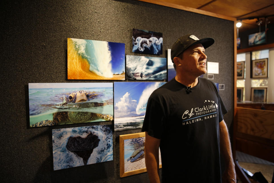 Clark Little, a wave photographer from the North Shore of Oahu, speaks during an interview at his gallery in Haleiwa, Hawaii, Friday, May 13, 2022. (AP Photo/Caleb Jones)