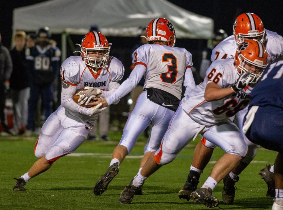 Byron QB Braden Smith, No. 3, hands off to Chandler Binkley on Byron's drive to their first touchdown in the fourth quarter of the Class 3A state semifinal game in Elmhurst on Saturday, Nov. 20, 2021. Byron beat IC Catholic 15-14 in the final five seconds of the game.