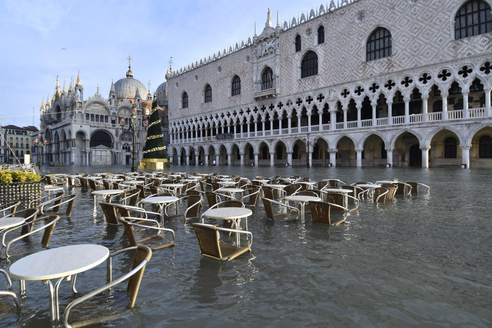 Cafè tables and chairs are partially covered in water during a high tide of 4.72 feet in St Mark's Square, Venice, on Monday. (AP)