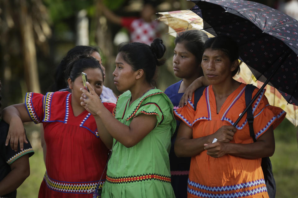 In this Nov. 26, 2018 photo, a group of Ngabe-Bugle women take photos during the second edition of the Panamanian indigenous games in Piriati, Panama. For two days, more than 100 competitors from the main indigenous groups of Panama, Guna, Embera, Ngabe-Bugle, converged for the second time to celebrate their ancestral games. (AP Photo/Arnulfo Franco)