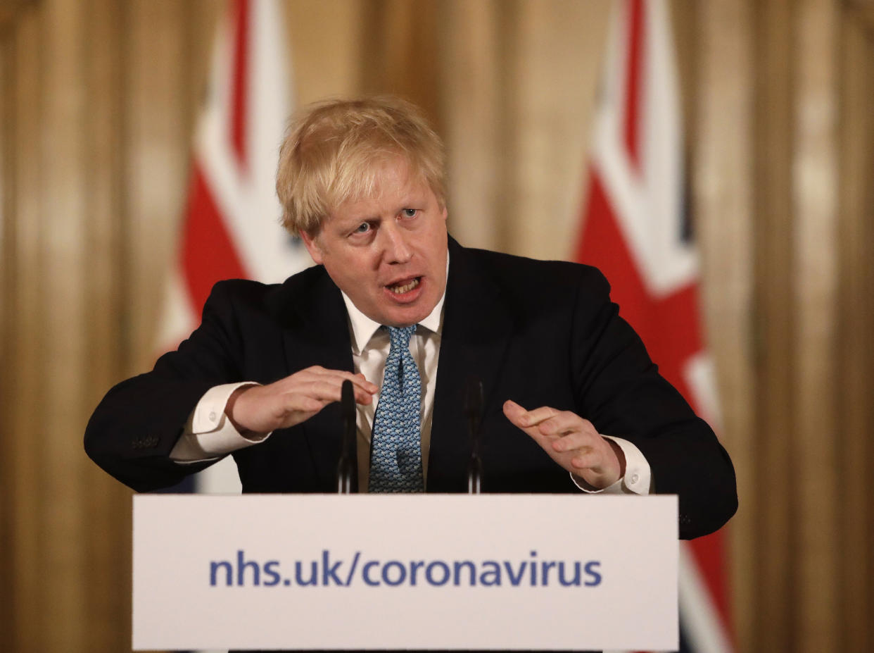 British Prime Minister Boris Johnson gestures as he gives a press conference about the ongoing situation with the COVID-19 coronavirus outbreak inside 10 Downing Street in London, Tuesday, March 17, 2020. For most people, the new coronavirus causes only mild or moderate symptoms, such as fever and cough. For some, especially older adults and people with existing health problems, it can cause more severe illness, including pneumonia. (AP Photo/Matt Dunham, Pool)