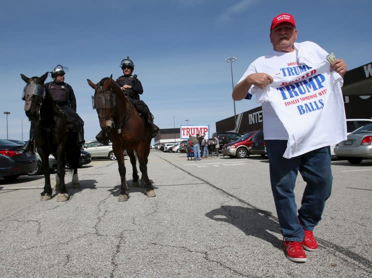 A vendor sells shirts as mounted police look on prior to a campaign rally for Republican presidential candidate Donald Trump in Cleveland in March. (Photo: Aaron Josefczyk/Reuters)