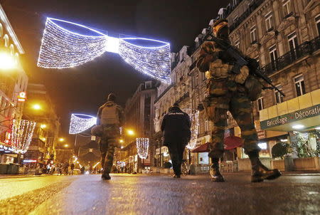 Belgian soldiers and police patrol in central Brussels on November 22, 2015, after security was tightened in Belgium following the fatal attacks in Paris. REUTERS/Yves Herman