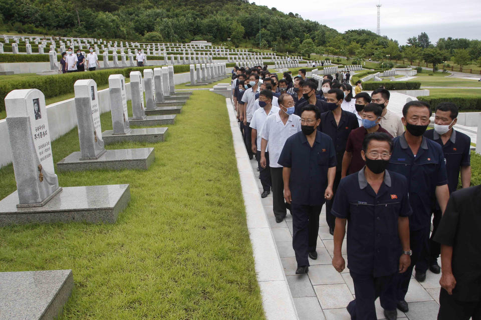 North Koreans visit the Fatherland Liberation War Martyrs Cemetery to pay respects to the monument to the fallen soldiers of the Korean People's Army in Pyongyang, North Korea, Thursday, June 25, 2020. North and South Korea on Thursday marked the 70th anniversary of the start of the Korean War with largely subdued commemorations amid the coronavirus pandemic, a day after the North abruptly halted a pressure campaign against the South. (AP Photo/Cha Song Ho)