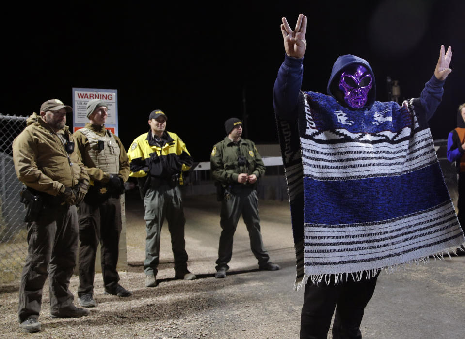 A man in an alien mask stands at an entrance to the Nevada Test and Training Range near Area 51 Friday, Sept. 20, 2019, outside of Rachel, Nev. People gathered at the gate inspired by the "Storm Area 51" internet hoax. (AP Photo/John Locher)