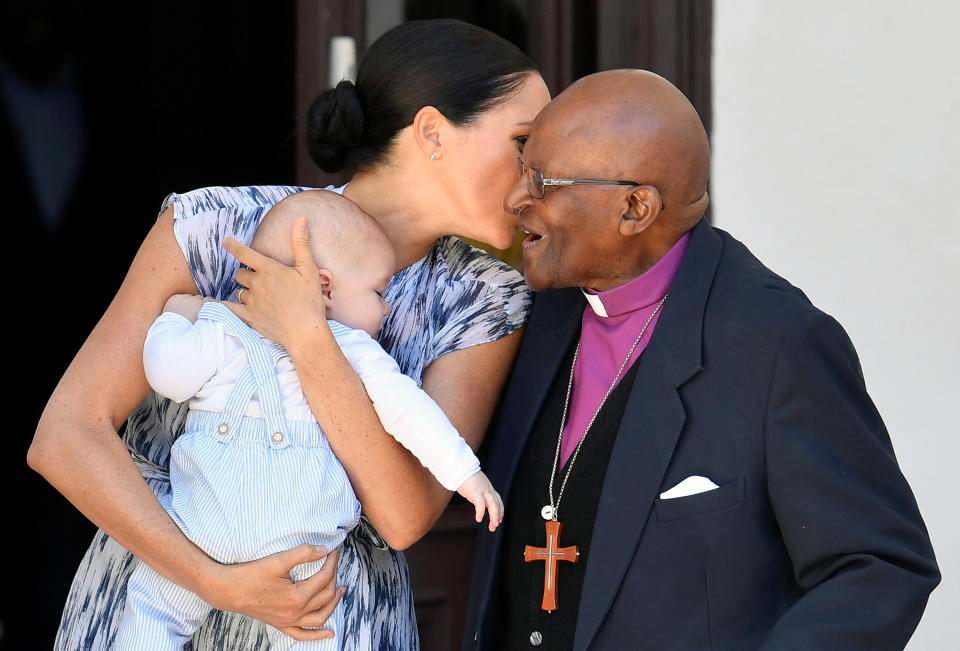 Meghan Markle kisses Archbishop Desmond Tutu while holding Archie