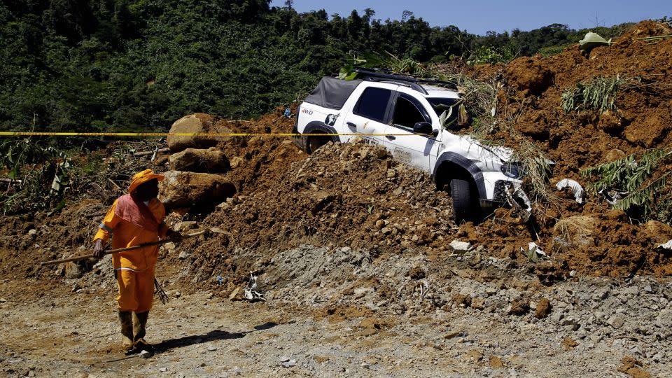 A member of the rescue team stands at the area of a landslide in the road between Quibdo and Medellin, Choco department, Colombia on January 13, 2024. - Fredy Builes/AFP/Getty Images