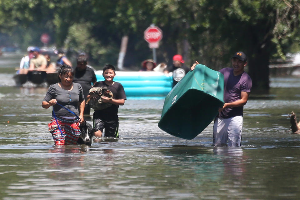 People walk with their possessions out of a flooded area of Port Arthur, Texas on Aug.&nbsp;31, 2017. (Photo: Carlo Allegri / Reuters)