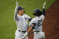 New York Yankees' Aaron Judge, left, celebrates with Giancarlo Stanton after hitting a solo home run off Boston Red Sox starting pitcher Zack Godley during the first inning of a baseball game Saturday, Aug. 1, 2020, in New York. (AP Photo/John Minchillo)