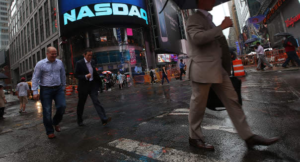 NEW YORK, NY - AUGUST 22:  People walk past the NASDAQ MarketSite in Times Square after trading was halted on all Nasdaq-listed stocks on August 22, 2013 in New York City.  A technical glitch caused all Nasdaq stock trading to be halted this afternoon.  (Photo by Mario Tama/Getty Images)