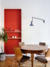 <p>Whether your space has a customized niche or you want to reimagine an existing quirk, consider floating shelves your solution. They'll allow you to get some real practical use of an otherwise unused divot. Here, Emil Dervish made this space pop even more by giving the floating shelves a bright orange-red backdrop. </p>