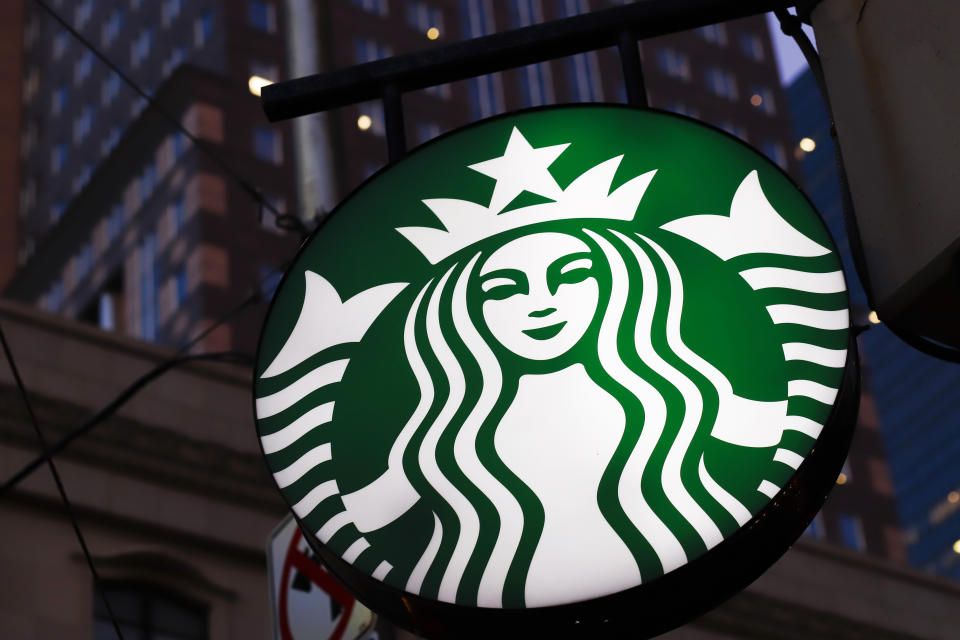 This June 26, 2019, photo shows a Starbucks sign outside a Starbucks coffee shop in downtown Pittsburgh. Starbucks customers in Canada will soon be able to down fake meat with their Frappuccinos. The coffee chain said Wednesday, Feb. 26, 2020, that it will soon start selling a sandwich featuring a meat-free patty from Beyond Meat, the El Segundo, California-based company whose patties are already found at other fast food chains. (AP Photo/Gene J. Puskar)