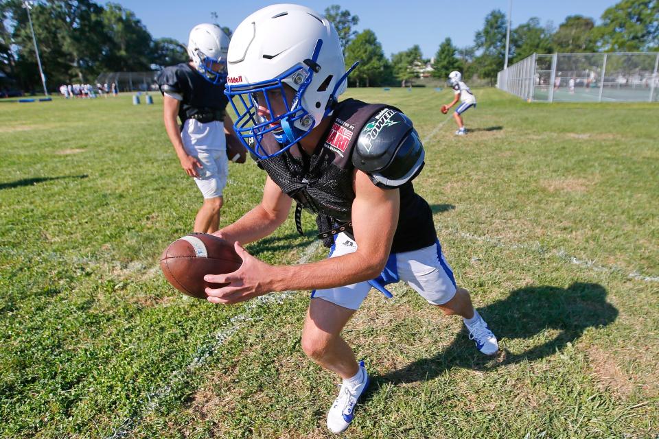 QB Cameron Burke practices during the Fairhaven High School football team practice held at Cushman Park in Fairhaven.