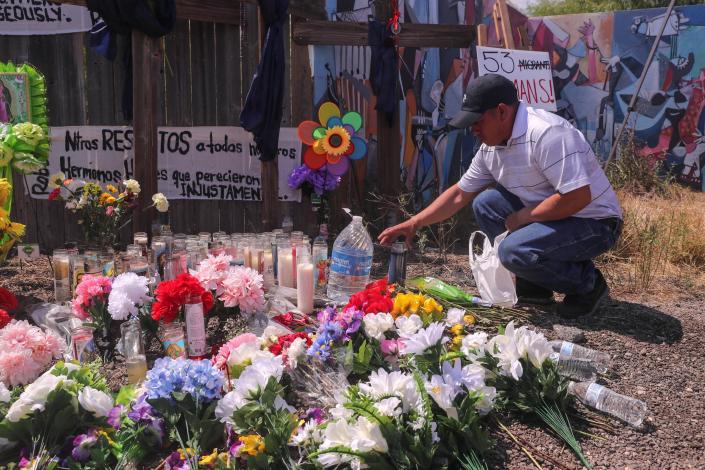 Victor Hernandez, an immigrant to the United States from Honduras, places a candle on a memorial in San Antonio, on June 29, 2022. The memorial is dedicated to 53 migrants who  died in an abandoned trailer on a remote road in Southeast San Antonio.