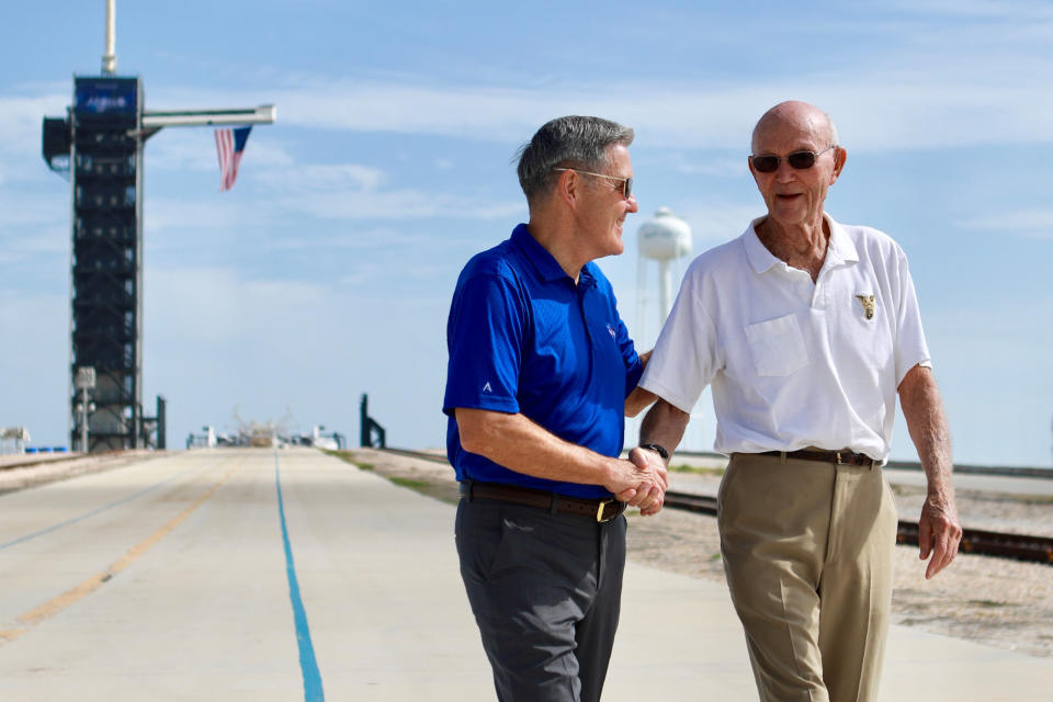 In this Tuesday, July 16, 2019 photo made available by NASA, astronaut Michael Collins, right, speaks to Kennedy Space Center Director Bob Cabana at Launch Complex 39A, about the moments leading up to launch at 9:32 a.m. on July 16, 1969, and what it was like to be part of the first mission to land on the moon. Collins was orbiting in the Command Module, while Neil Armstrong and Buzz Aldrin went to the surface in the Lunar Module. (Frank Michaux/NASA via AP)