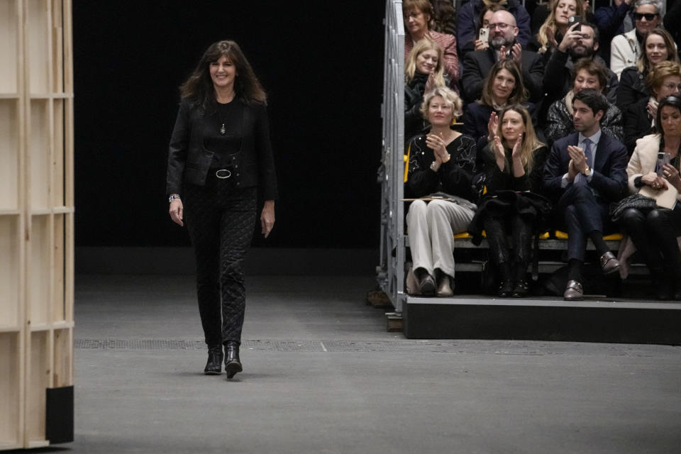 Designer Virginie Viard accepts applause at the end of the Chanel Haute Couture Spring-Summer 2023 collection presented in Paris, Tuesday, Jan. 24, 2023. (AP Photo/Christophe Ena)