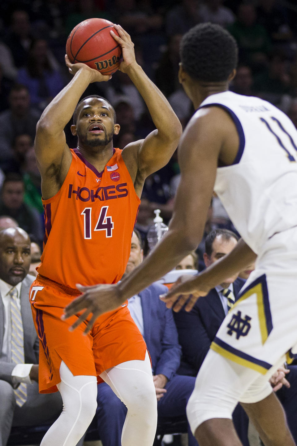 Virginia Tech's P.J. Horne (14) shoots a 3-pointer in front of Notre Dame's Juwan Durham (11) during the first half of an NCAA college basketball game Saturday, March 7, 2020, in South Bend, Ind. (AP Photo/Robert Franklin)