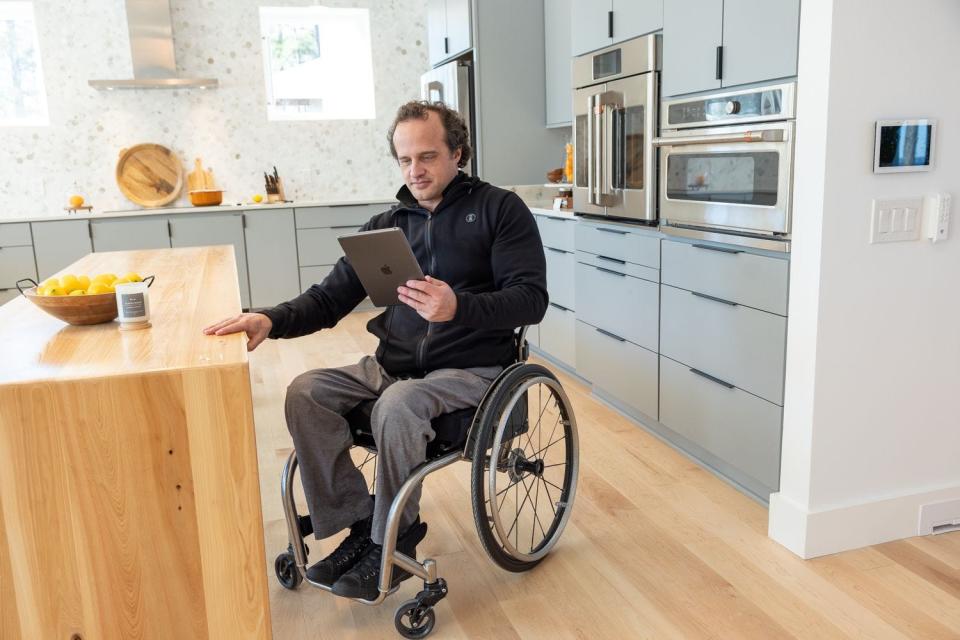 Retired Air Force Staff Sgt. Brian Schiefer looks over the computer controls to the home built for him by the R.I.S.E. program of the Gary Sinise Foundation. The mortgage-free home was presented to Schiefer on Wednesday.