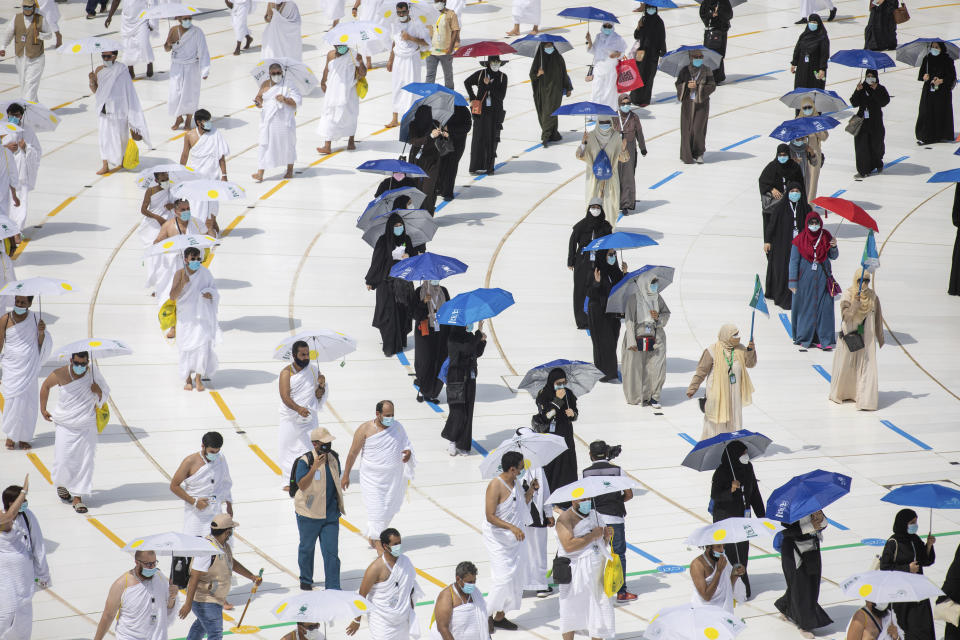 In this photo released by the Saudi Media Ministry, a limited numbers of pilgrims move several feet apart, circling the cube-shaped Kaaba in the first rituals of the hajj, as they keep social distancing to limit exposure and the potential transmission of the coronavirus, at the Grand Mosque in the Muslim holy city of Mecca, Saudi Arabia, Wednesday, July 29, 2020. The hajj, which started on Wednesday, is intended to bring about greater humility and unity among Muslims. (Saudi Media Ministry via AP)