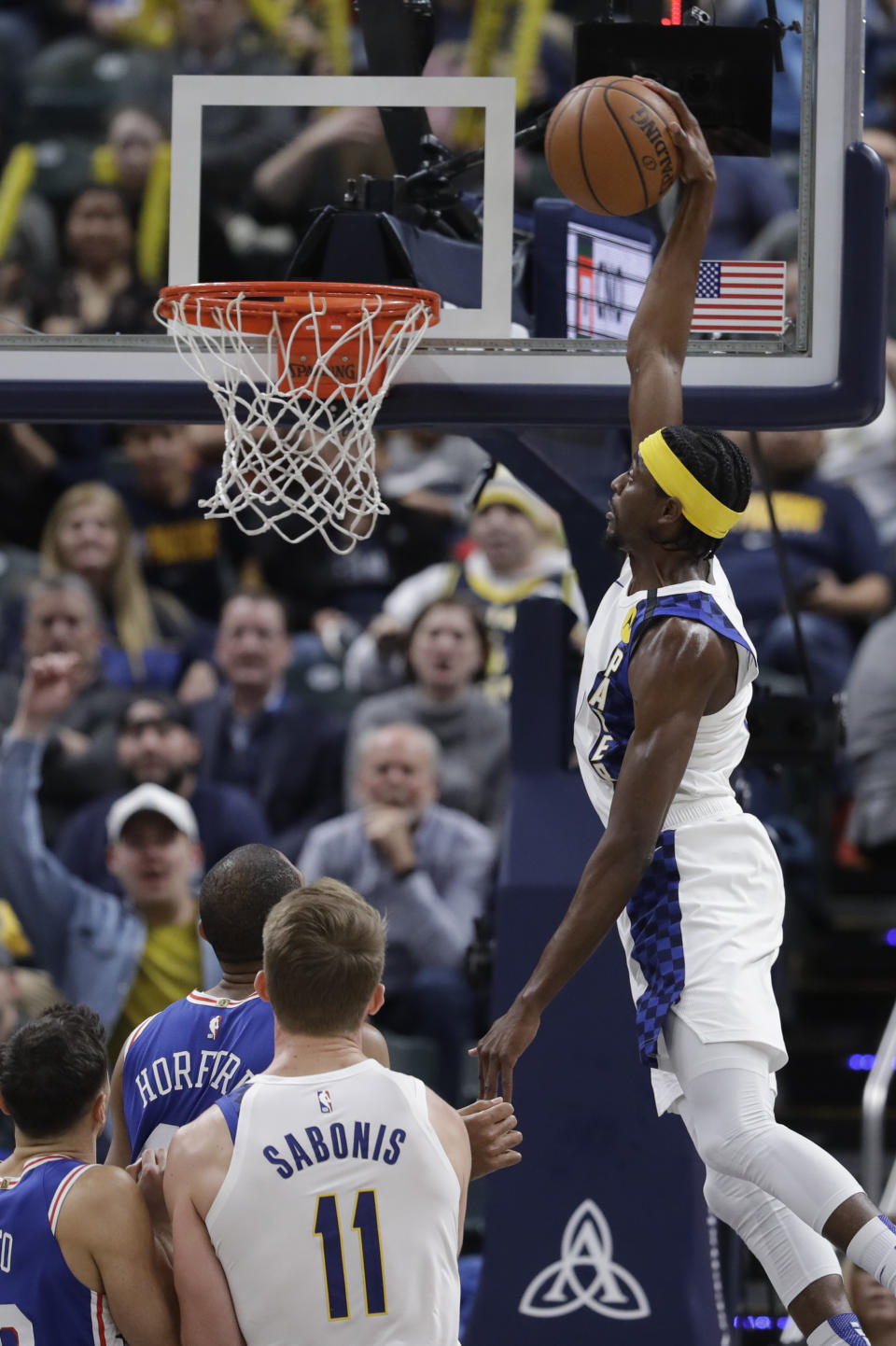 Indiana Pacers' Justin Holiday (8) dunks during the second half of an NBA basketball game against the Philadelphia 76ers, Monday, Jan. 13, 2020, in Indianapolis. Indiana won 101-95. (AP Photo/Darron Cummings)