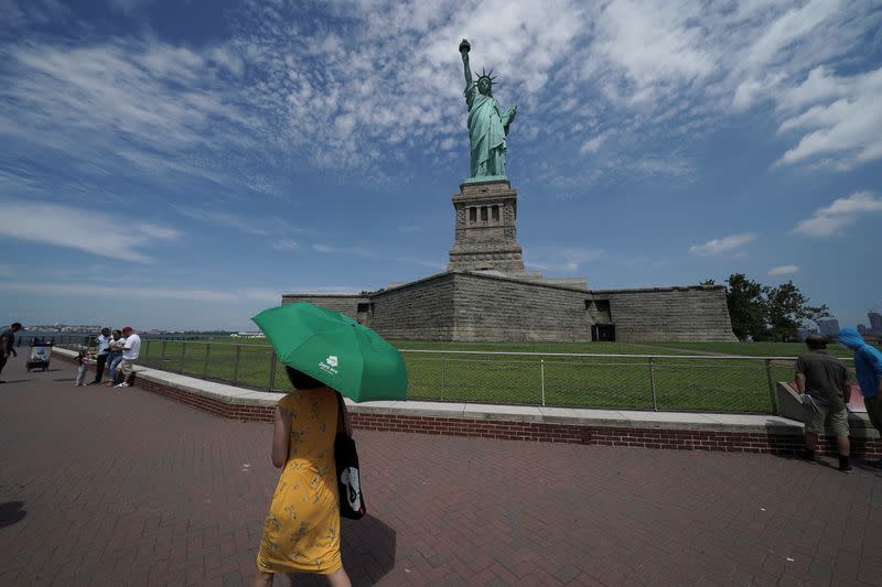 People are seen at the Statue of Liberty as New York enters Phase 4 of reopening following the outbreak of the coronavirus disease (COVID-19) in New York City