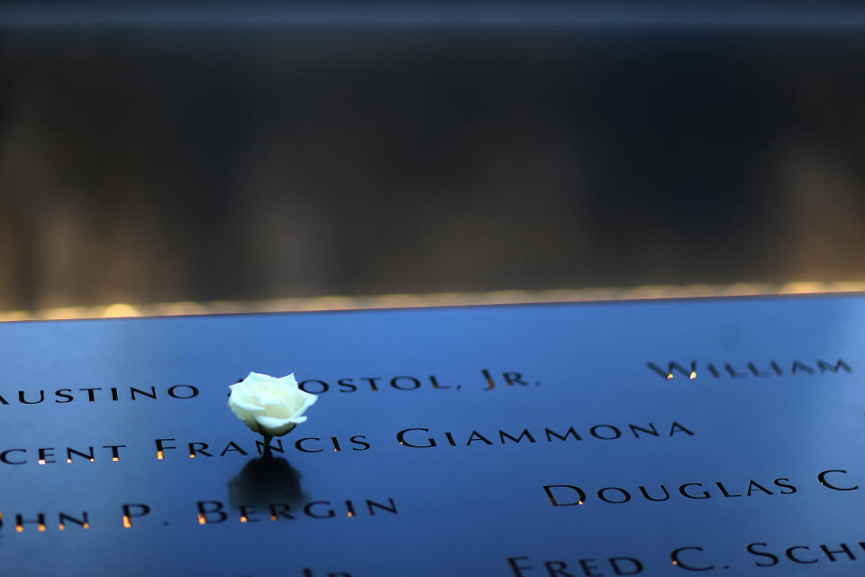 A flower is placed on Vincent Francis Giammona's name at the South Tower Memorial Pool before memorial observances held at the site of the World Trade Center in New York, Thursday, Sept. 11, 2014. (AP Photo/The New York Times, Chang W. Lee, Pool)