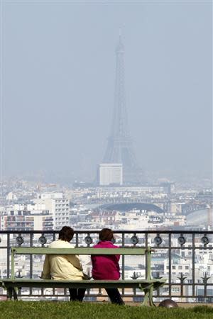 A general view shows the Eiffel tower and the Paris skyline through a small-particle haze from the Parc de St-Cloud, near Paris March 13, 2014 as warm and sunny weather continues in France. Residents and visitors to Paris basking in a streak of unseasonable sunshine were also being treated with a dangerous dose of particles from car fumes that pushed air pollution to levels above other northern European capitals this week. REUTERS/Charles Platiau