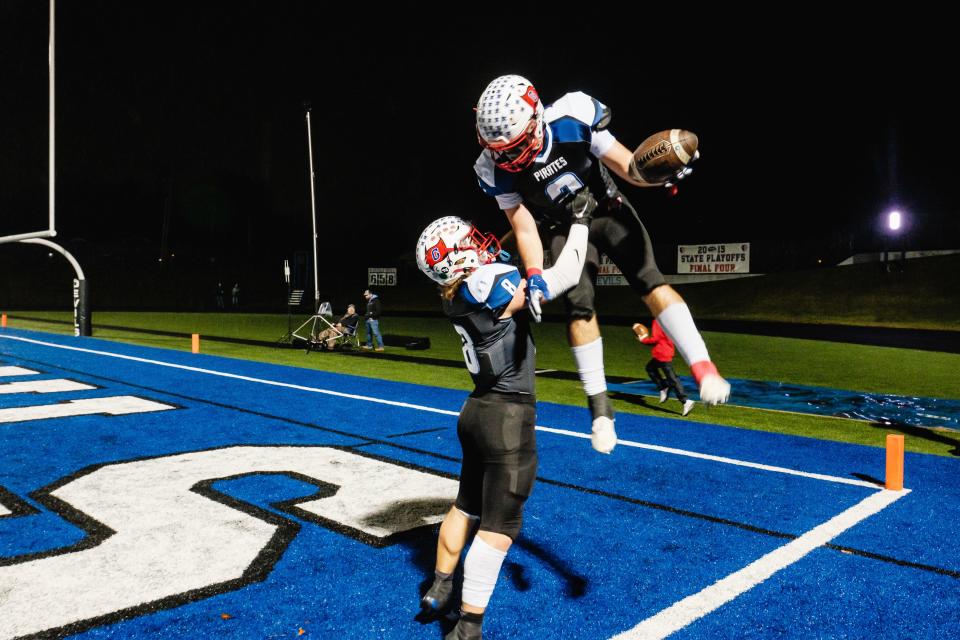Garaway's Dillon Soehnlen is lifted into the air after scoring a touchdown by teammate Jackson Reifenschneider during the Division VI, Region 23 final against West Jefferson, Friday, Nov. 17 at John D. Sulsberger Memorial Stadium in Zanesville, Ohio.
