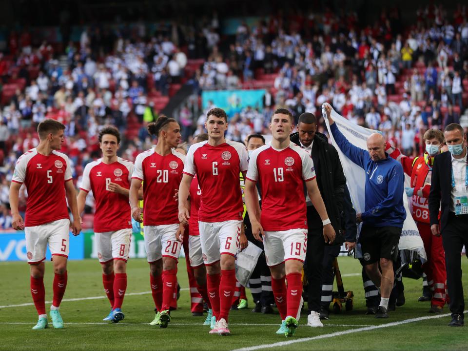 Christian Eriksen is escorted off of the field by team mates and medics on a stretcher (Getty Images)