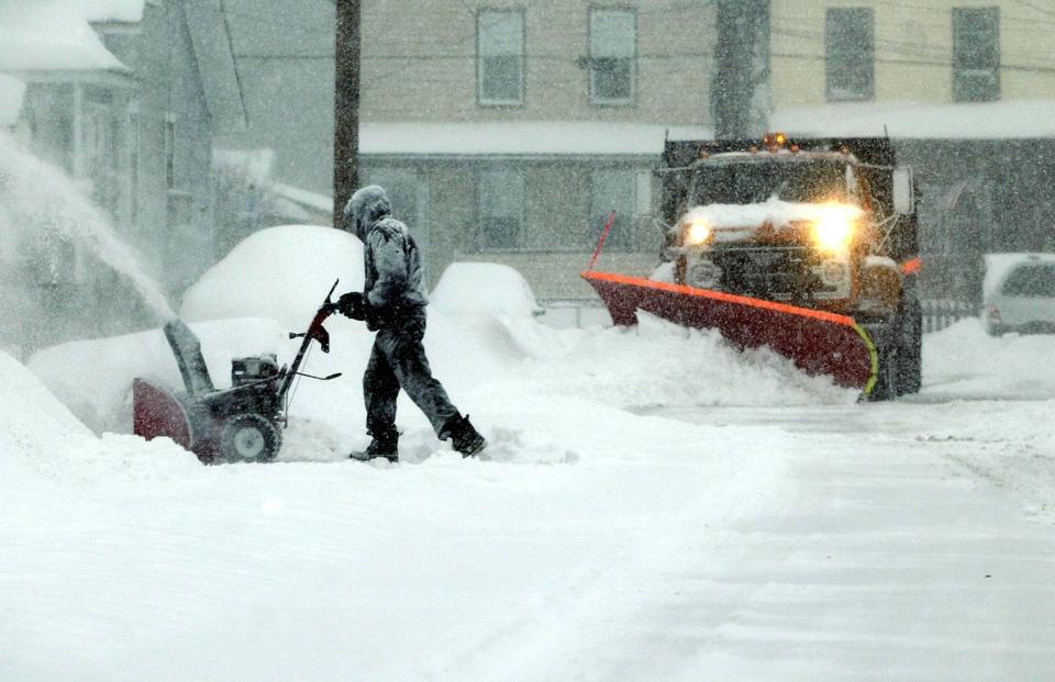 The streets are busy with people clearing snow during the blizzard on February 17, 2003 when almost two feet of snow blanketed the area.