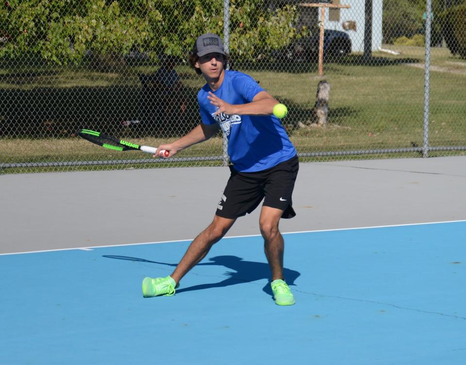 Aden Brake of Gibraltar Carlson hits a shot against Bedford’s Noah Kaplan at No. 1 singles.