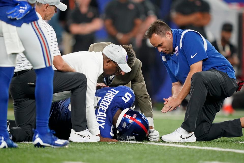 New York Giants trainers check on defensive end Kayvon Thibodeaux after he was injured during the first half against the Cincinnati Bengals.