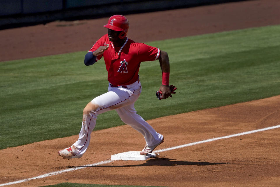 Los Angeles Angels' Justin Upton rounds third to score on a base hit by Kurt Suzuki during the second inning of a spring training baseball game against the Kansas City Royals, Wednesday, March 24, 2021, in Tempe, Ariz. (AP Photo/Matt York)