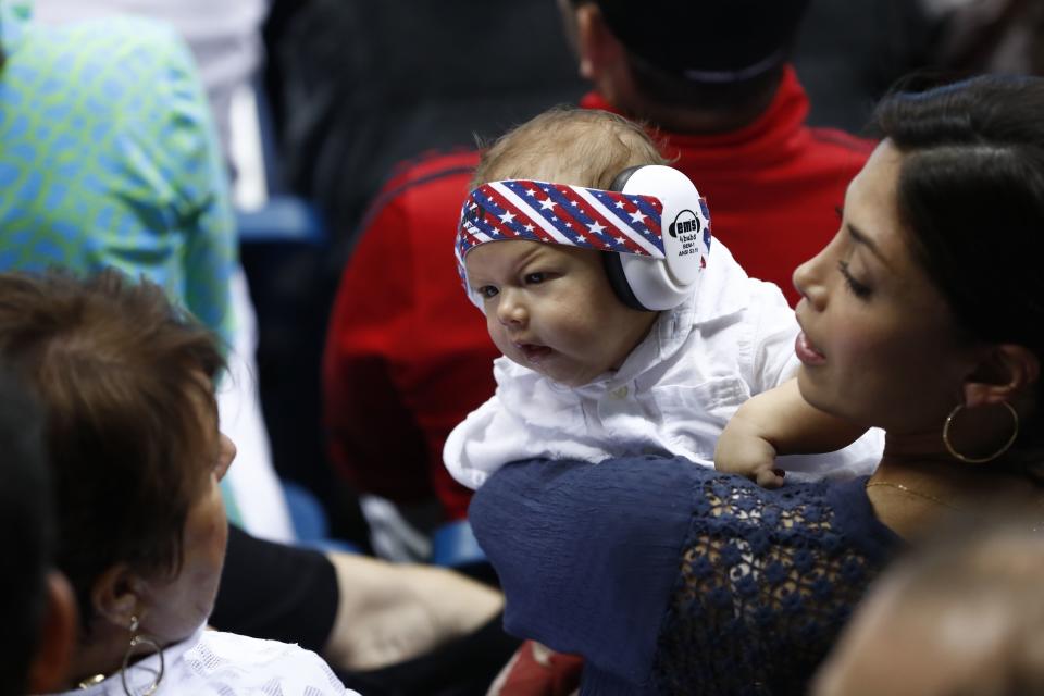 USA's Michael Phelps' son Boomer (C) looks at his grandmother Deborah while in the arms of his mother Nicole Johnson during swimming events at the Rio 2016 Olympic Games at the Olympic Aquatics Stadium in Rio de Janeiro on August 11, 2016.   / AFP / Odd ANDERSEN        (Photo credit should read ODD ANDERSEN/AFP/Getty Images)