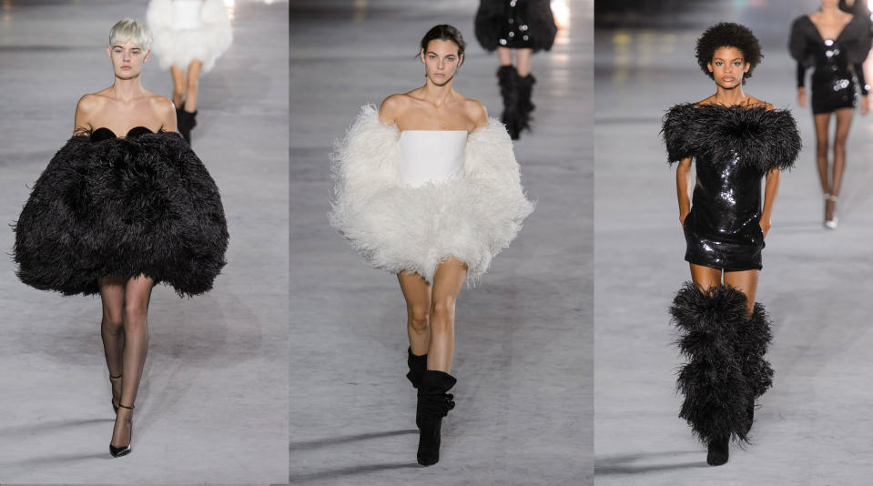 Models wear feather dresses, sleeves, and boots from the Spring 2018 Saint Laurent collection. (Photo: ImaxTree)