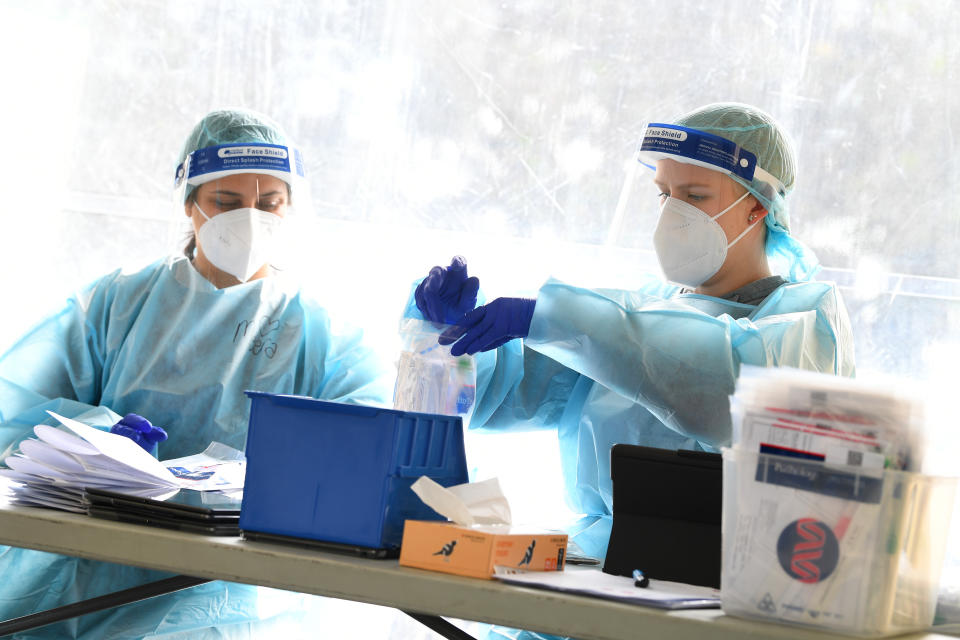 Healthcare workers are seen at a drive through pop up coronavirus testing facility in Clyde, Melbourne, Friday, September 18, 2020.