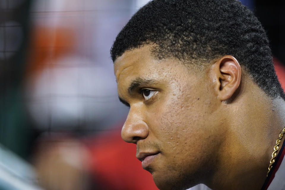 Washington Nationals' Juan Soto watches a baseball game from the dugout during the ninth inning against the New York Mets at Nationals Park, Monday, Aug. 1, 2022, in Washington. (AP Photo/Alex Brandon)