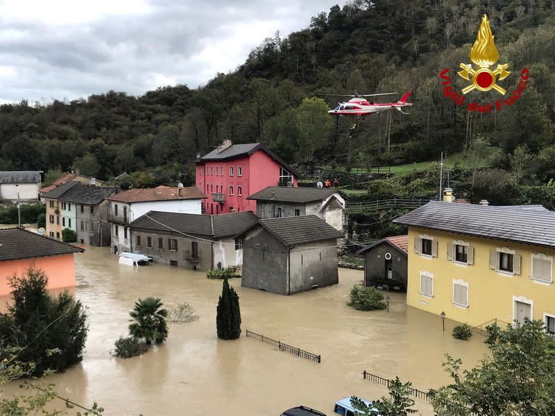 Fire brigade helicopter carries out rescue operation in flooded area in Ornavasso