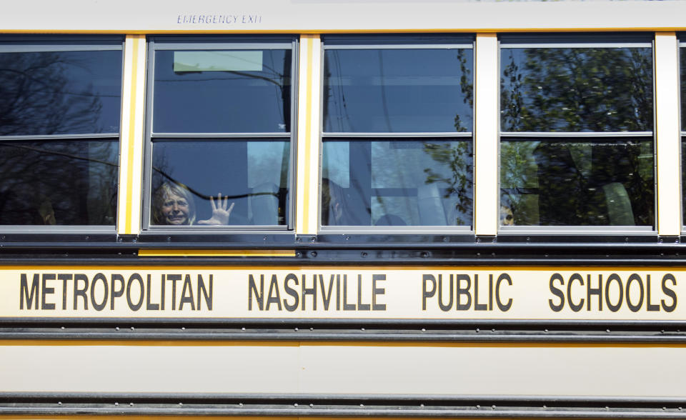 A child weeps while on the bus leaving The Covenant School following a mass shooting at the school in Nashville, Tenn., Monday, March 27, 2023. (Nicole Hester/The Tennessean via AP)
