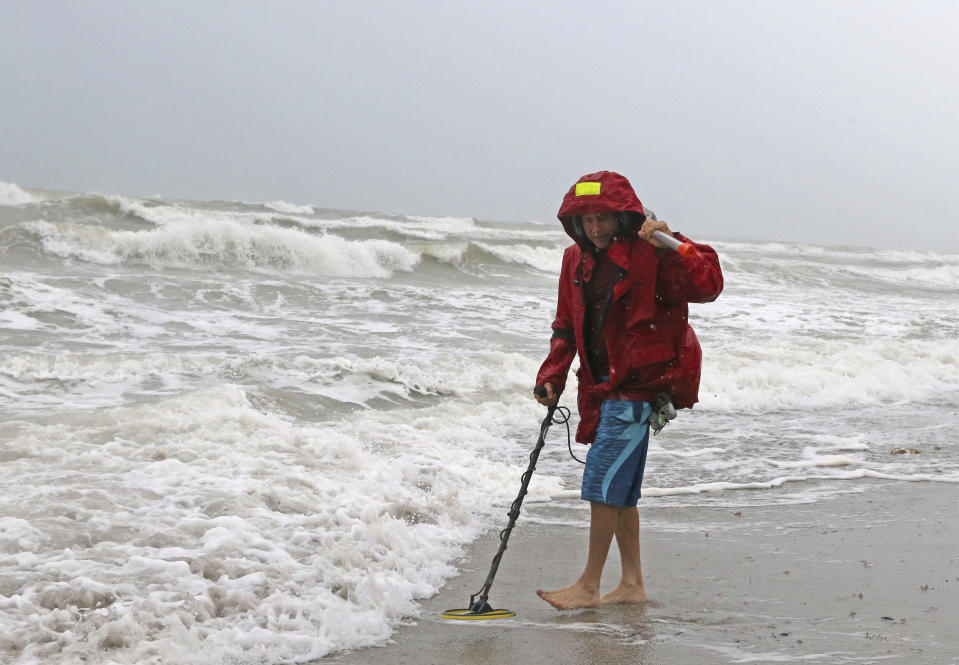 Local resident Mike Squillace looks for metal at Dania Beach, Fla., as Tropical Storm Gordon passes by South Florida with wind gust and heavy rainfall Monday, Sept. 3, 2018. (David Santiago/Miami Herald via AP)