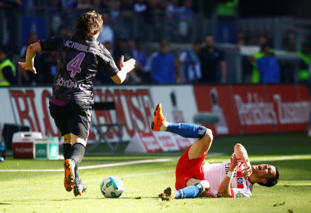 Soccer Football - Bundesliga - Hamburger SV vs SC Freiburg - Volksparkstadion, Hamburg, Germany - April 21, 2018 SC Freiburg's Caglar Soyuncu fouls Hamburg's Filip Kostic REUTERS/Morris Mac Matzen